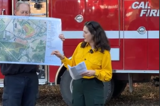 Melina Hammer in front of Cal Fire Truck showing plans for prescribed fire