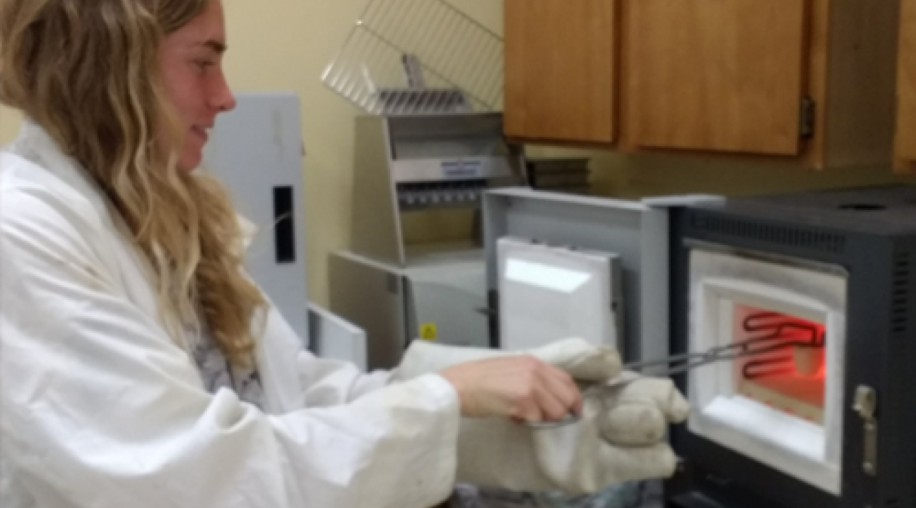 Student working with furnace in lab