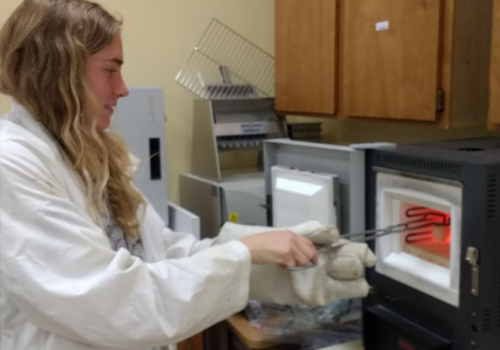 Student working with furnace in lab