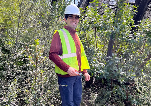 Student standing in forest