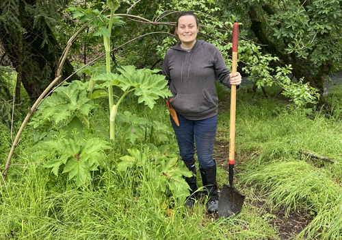 Student with shovel in garden