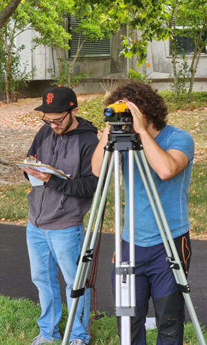 Students using surveying equipment