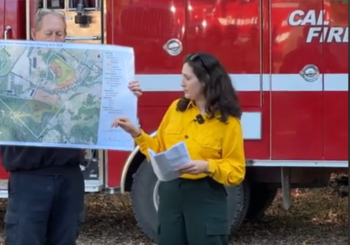 Melina Hammer in front of Cal Fire Truck showing plans for prescribed fire